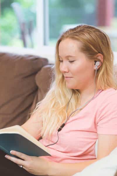 girl-relaxing-sofa-reading-book